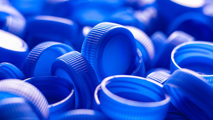 A box of blue plastic bottle caps
